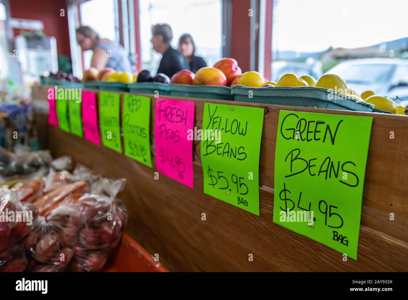 Written Signboard Close up of fluo colored hand written signboard at the food market ...
