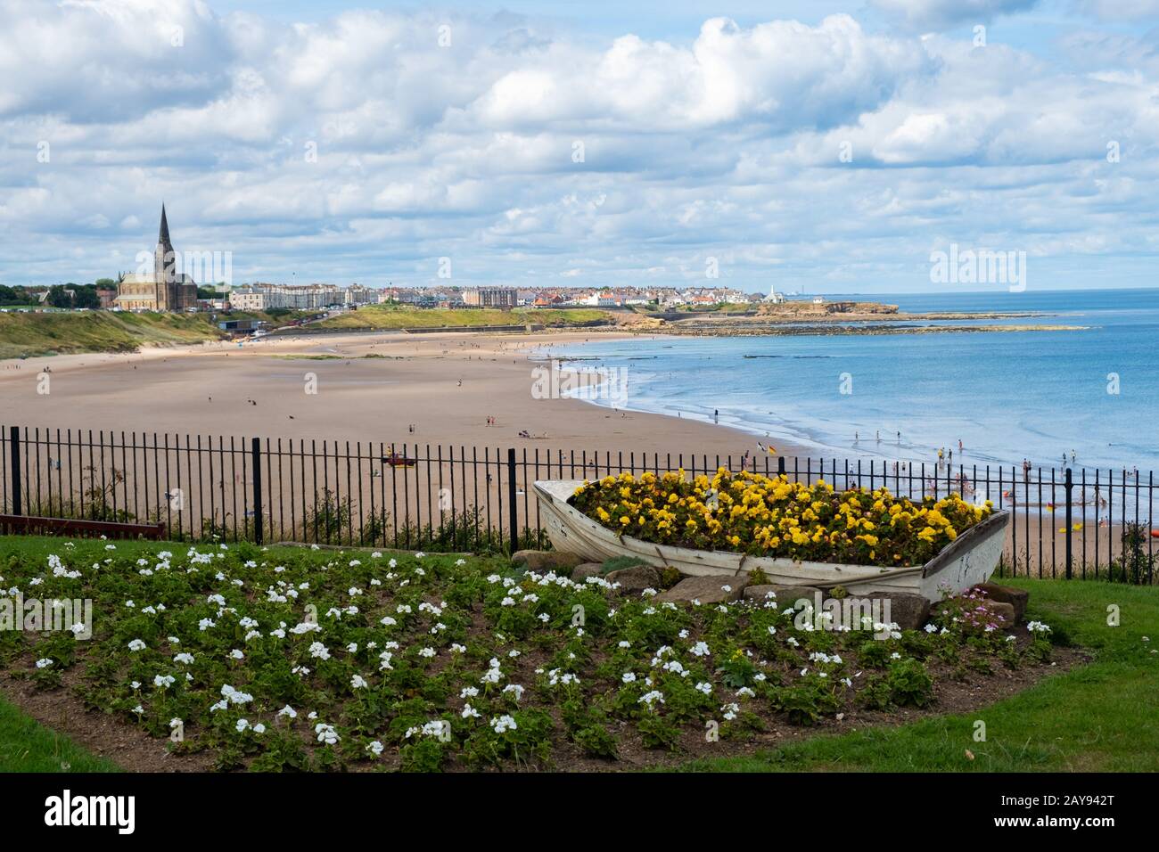 Ornamental Boat containing Flowers, with Tynemouth's Coastline in the background Stock Photo