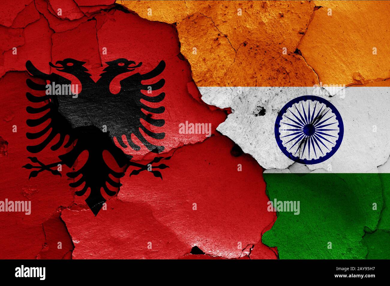flags of Albania and India painted on cracked wall Stock Photo