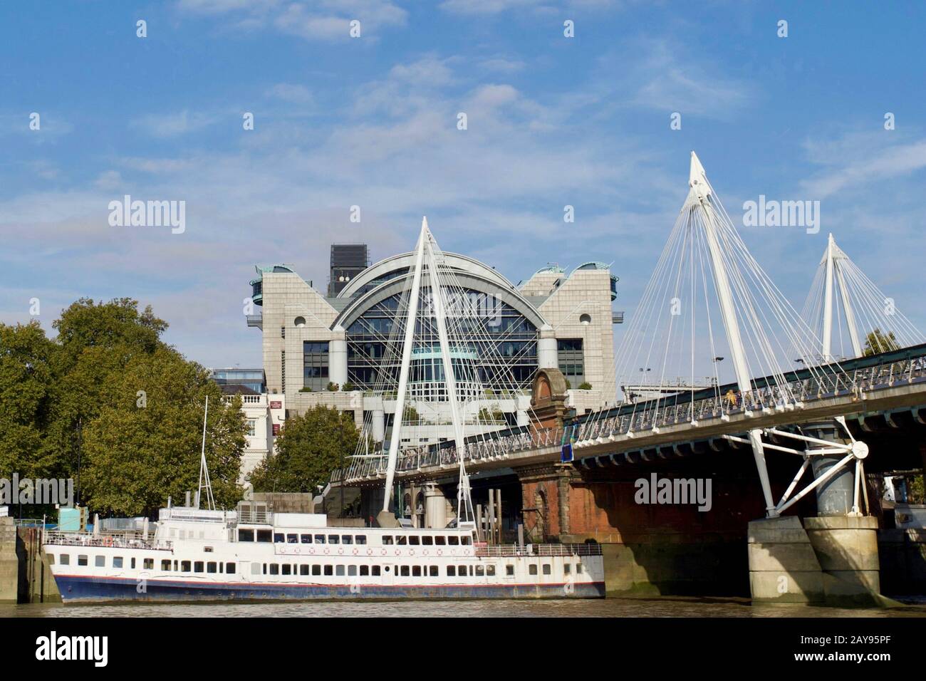 Hungerford & Golden Jubilee Bridges looking towards Charing Cross Station and Embankment Place, London, England. Stock Photo