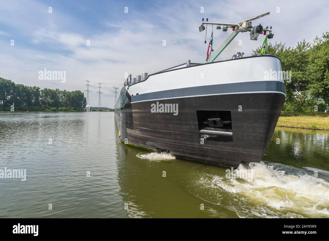 The bow of a riverboat maneuvering with the bow thruster on the Maas. Stock Photo