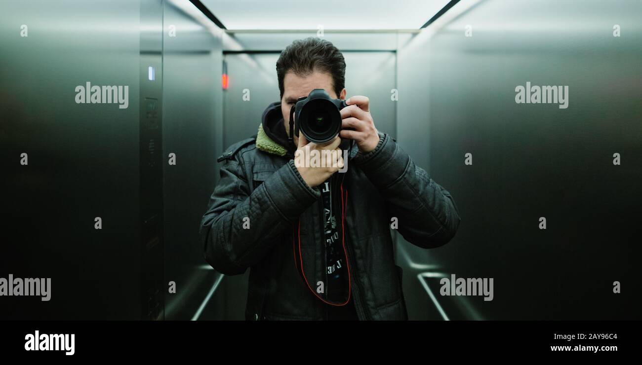 Photographer taking a cinematic mirror selfie with analog tungsten film look  and grain for ISO 800 Stock Photo