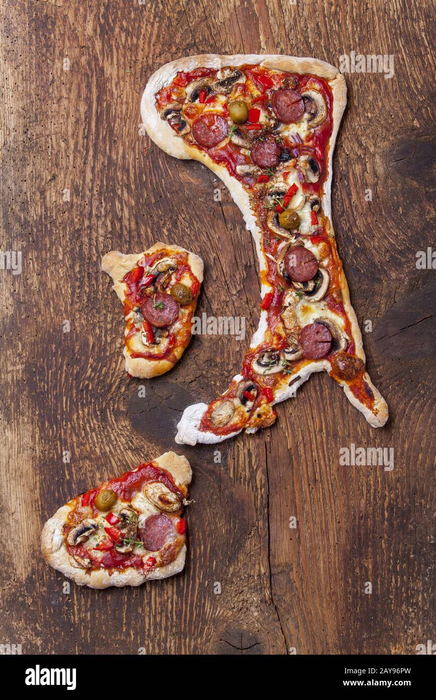 Pizza in the shape of the Italian peninsula Stock Photo
