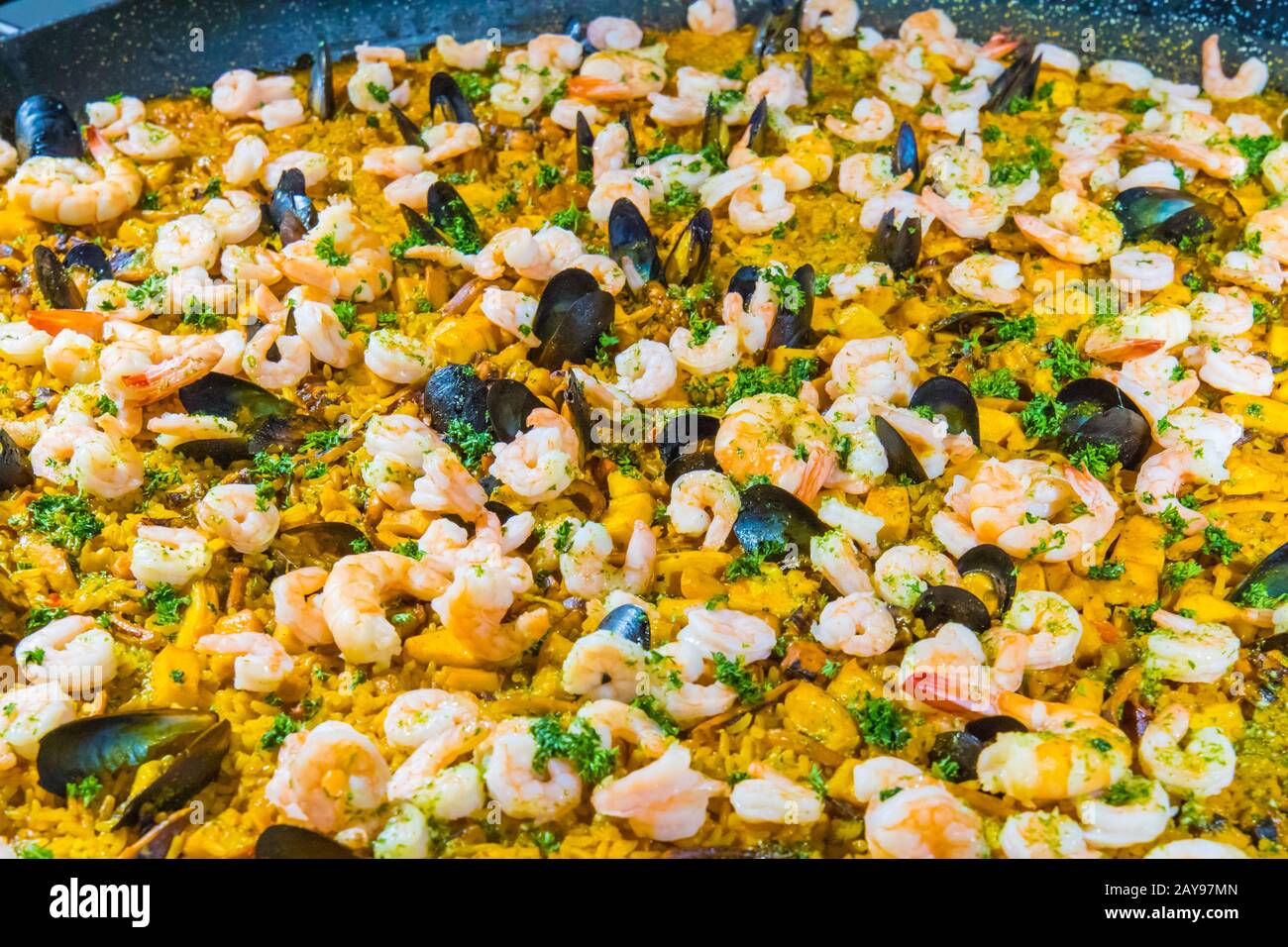 detail of the famous Spanish dish called Paella made with rice vegetables and seafood Stock Photo