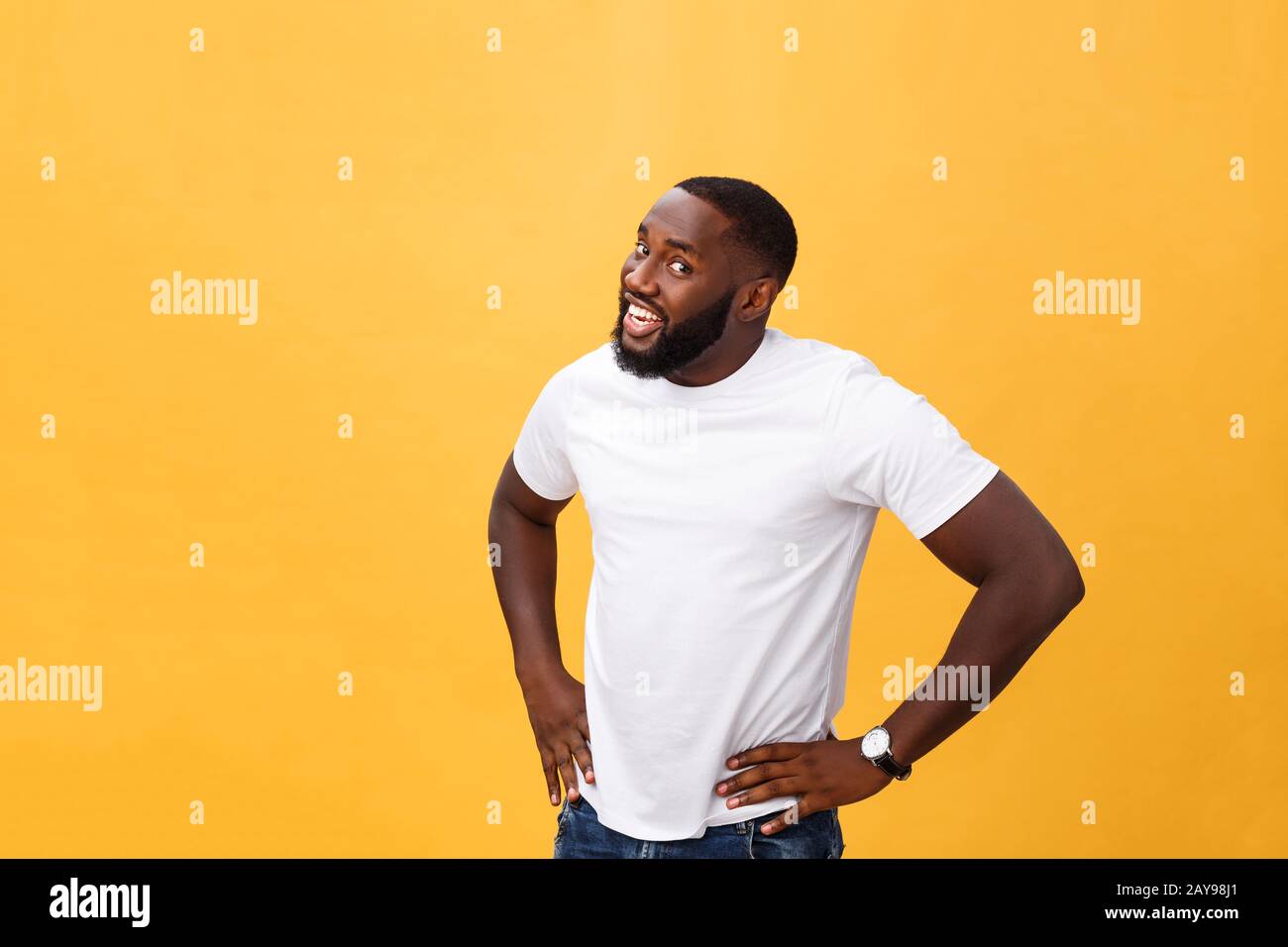 Portrait of handsome young african guy smiling in white t-shirt on ...