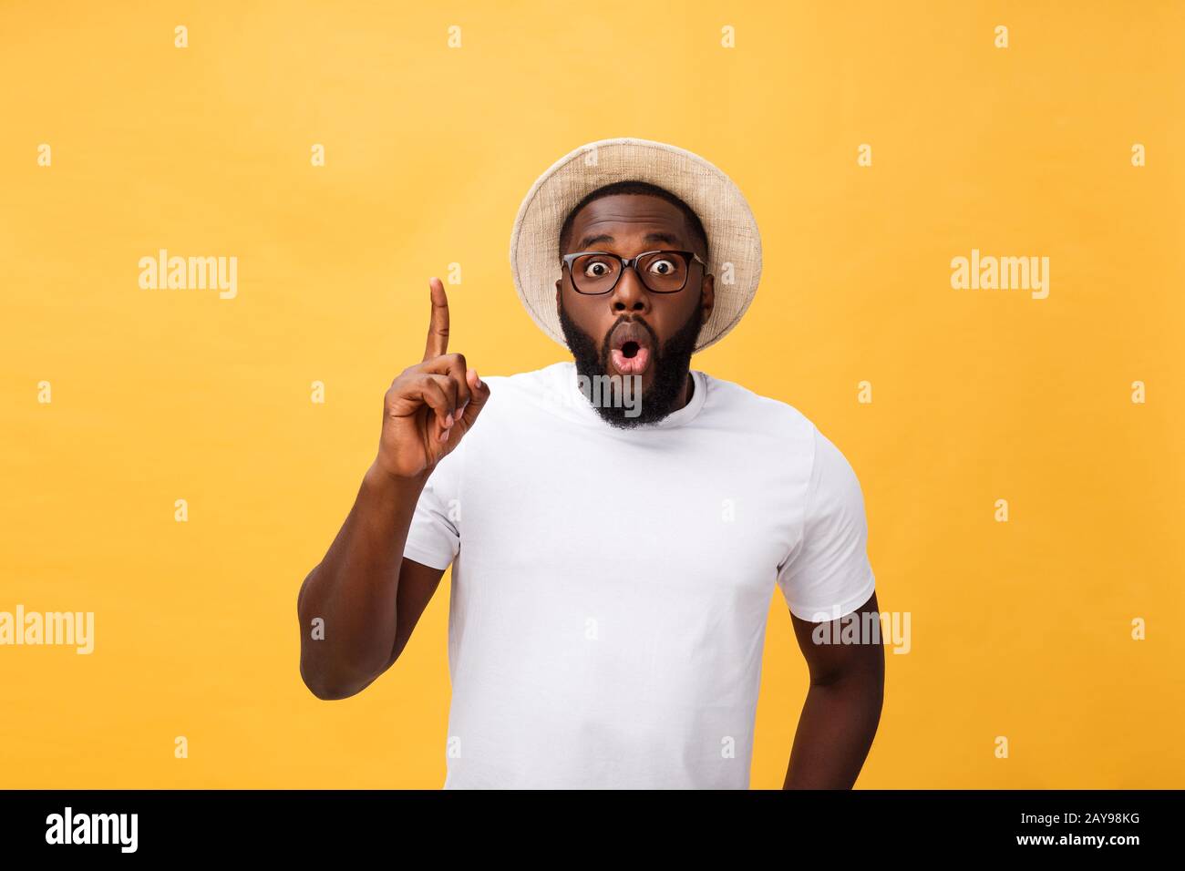 Young african american man over yellow background pointing upwards Stock Photo