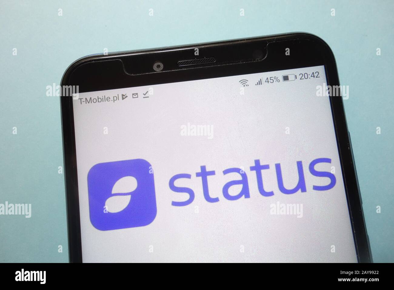 Status (SNT) cryptocurrency logo displayed on smartphone Stock Photo