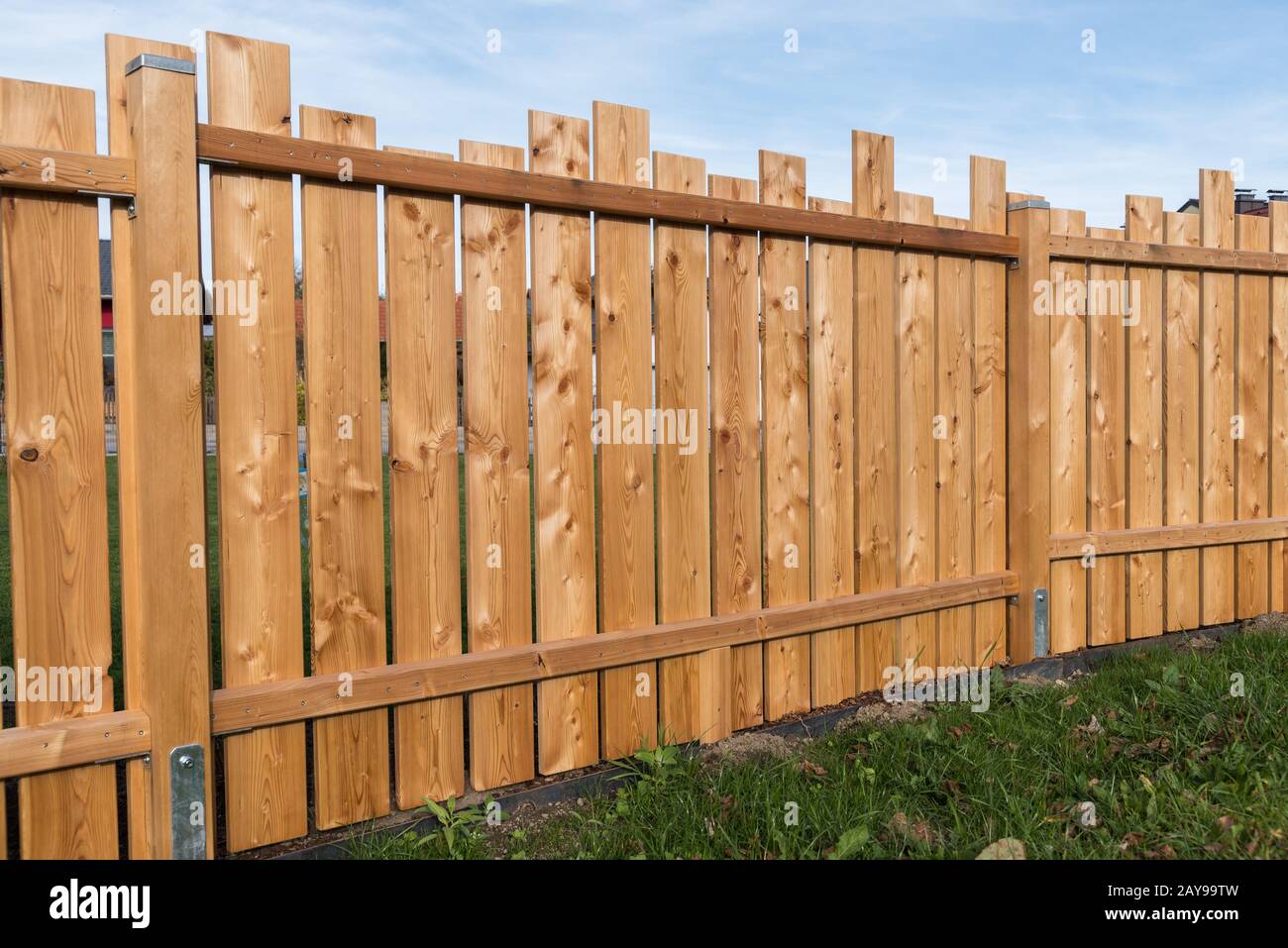Handmade privacy shield made of wooden boards also serves as noise protection Stock Photo