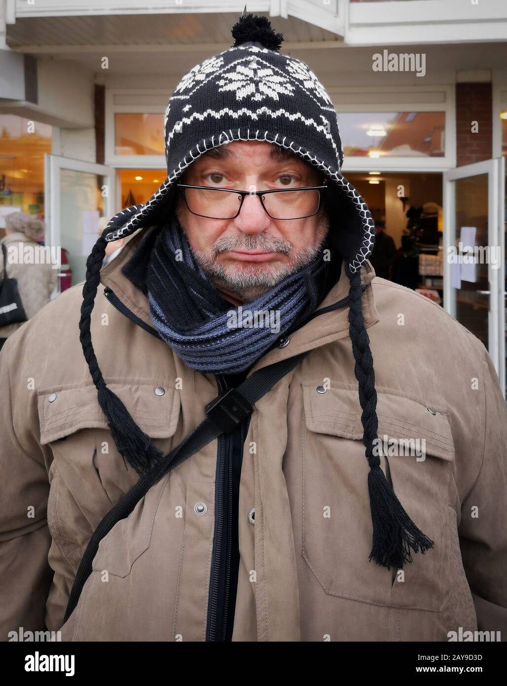 Old man with a grumpy look and knitted hat. Stock Photo