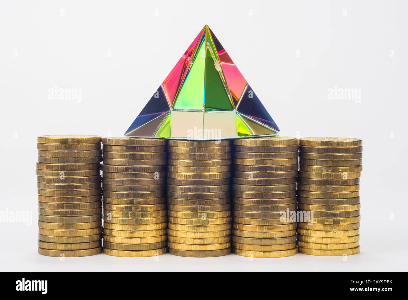Five piles of coins, they have a glass pyramid Stock Photo