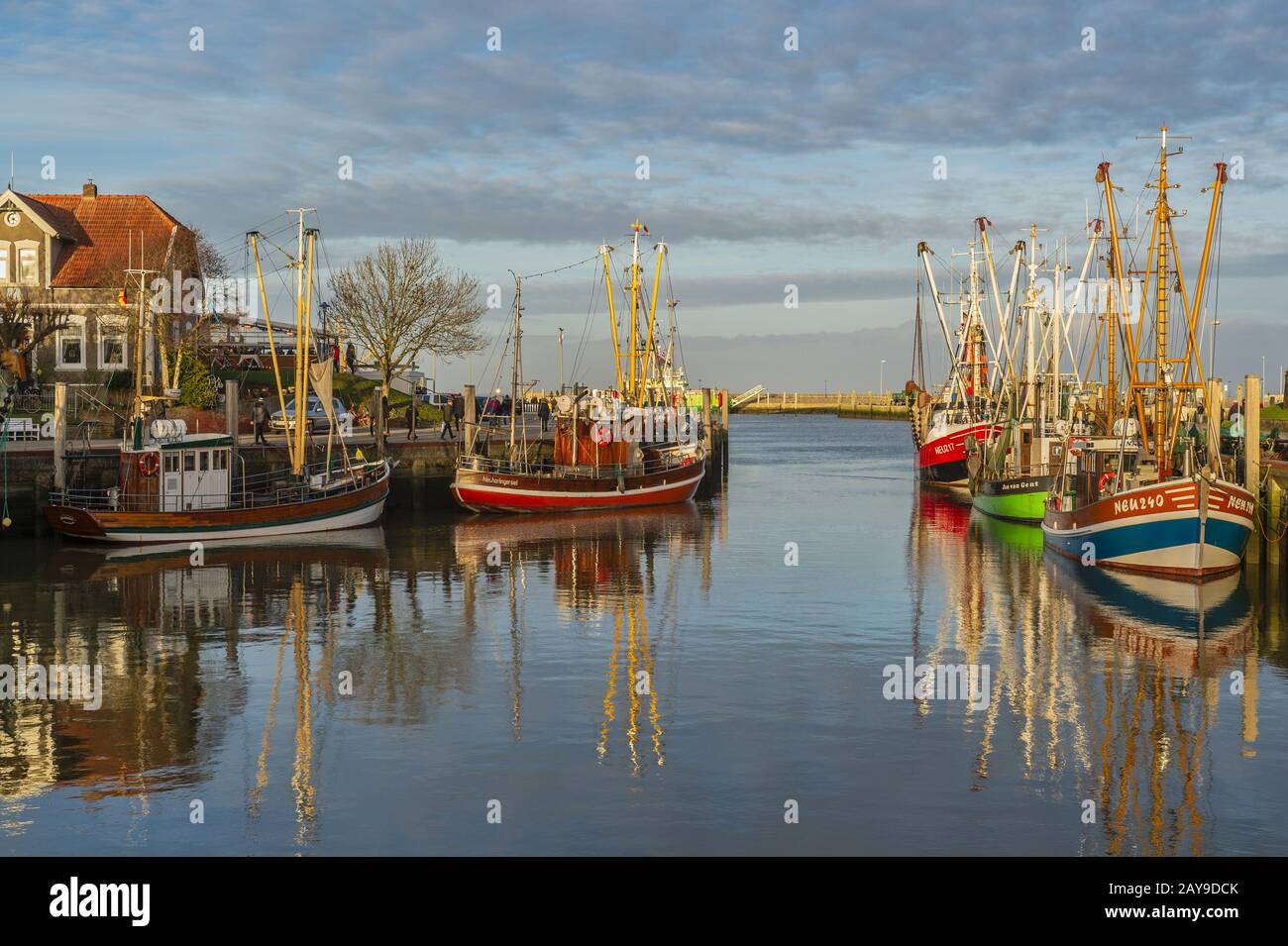 Fishing port and fishing boat in the evening sun. Stock Photo