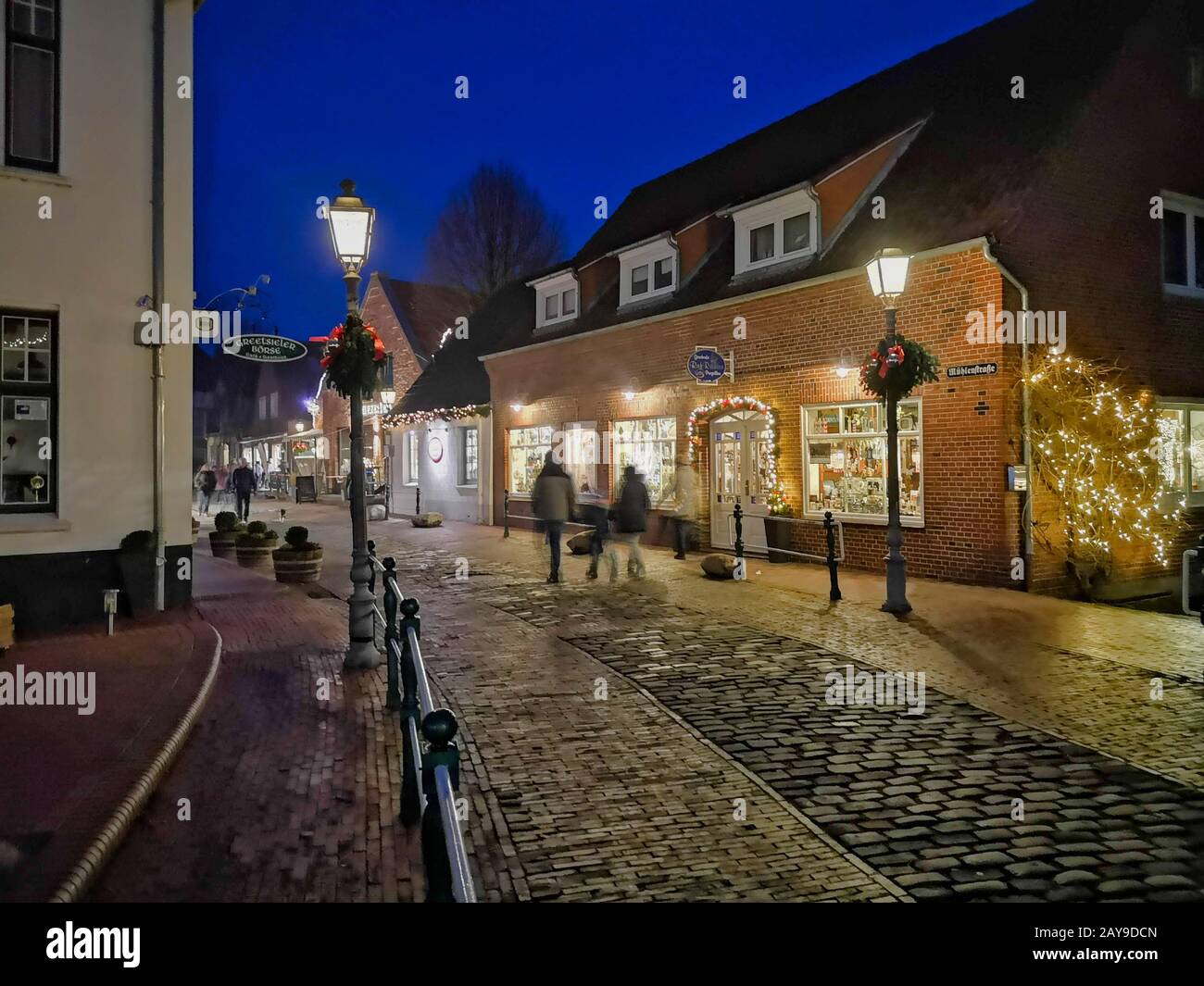 Night Scene. Historic old town and illuminated shop windows. Stock Photo