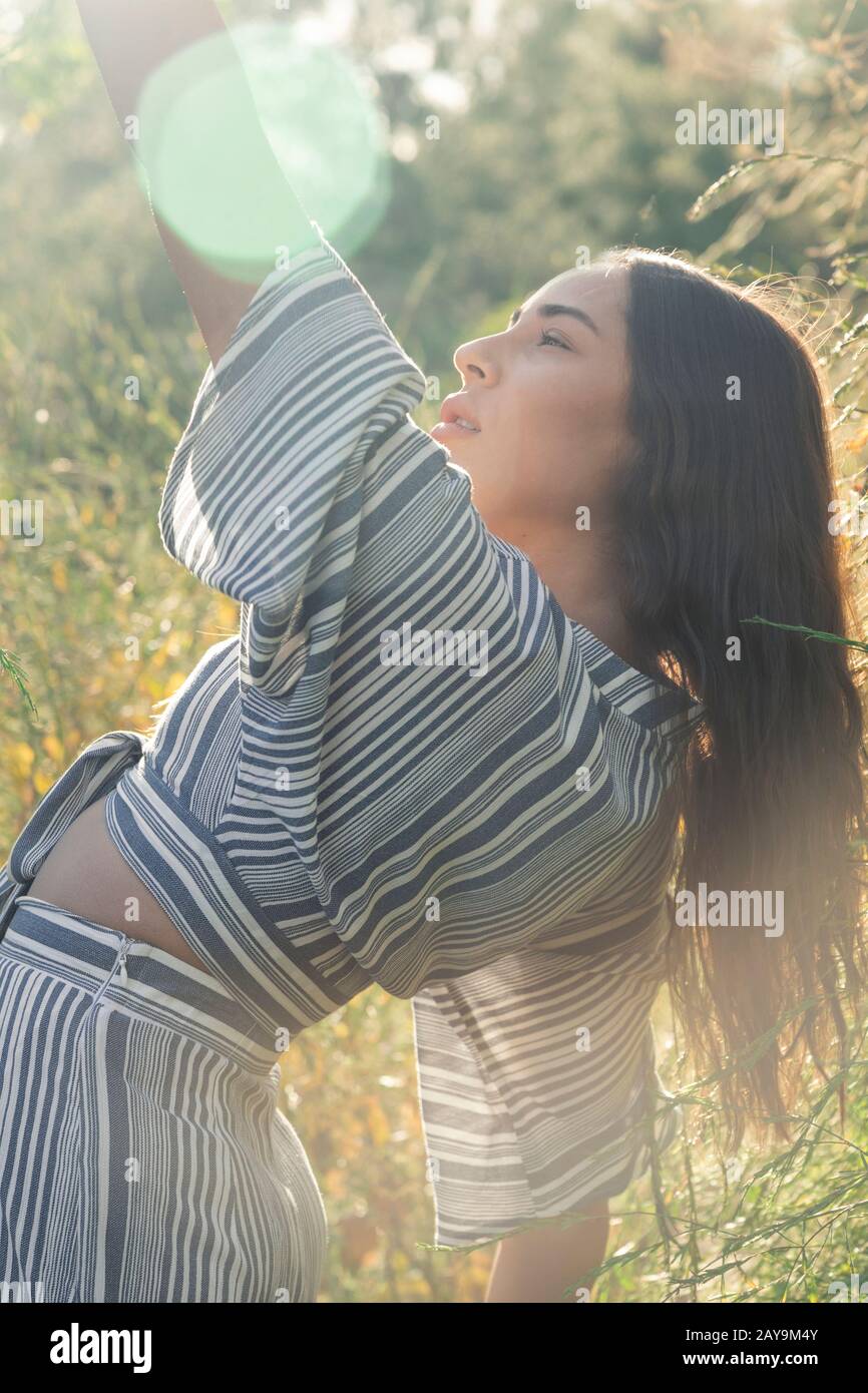 Long haired Latina in afternoon sun and fields Stock Photo