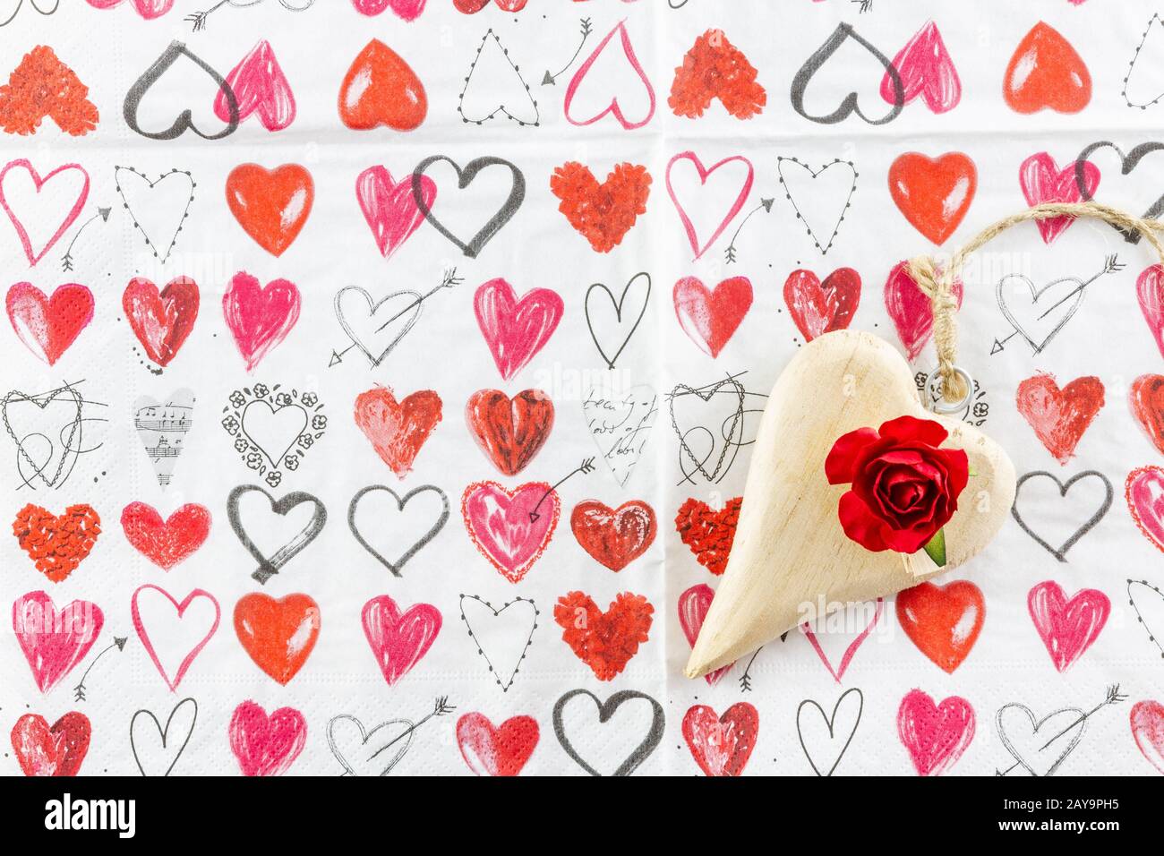 Wooden heart and red rose on paper for Valentines Day Stock Photo - Alamy