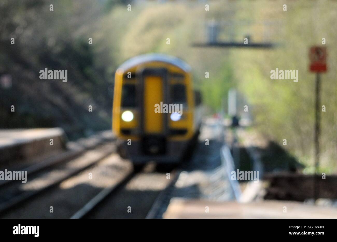 blurred image of a typical suburban pacer train arriving in a small railway station Stock Photo