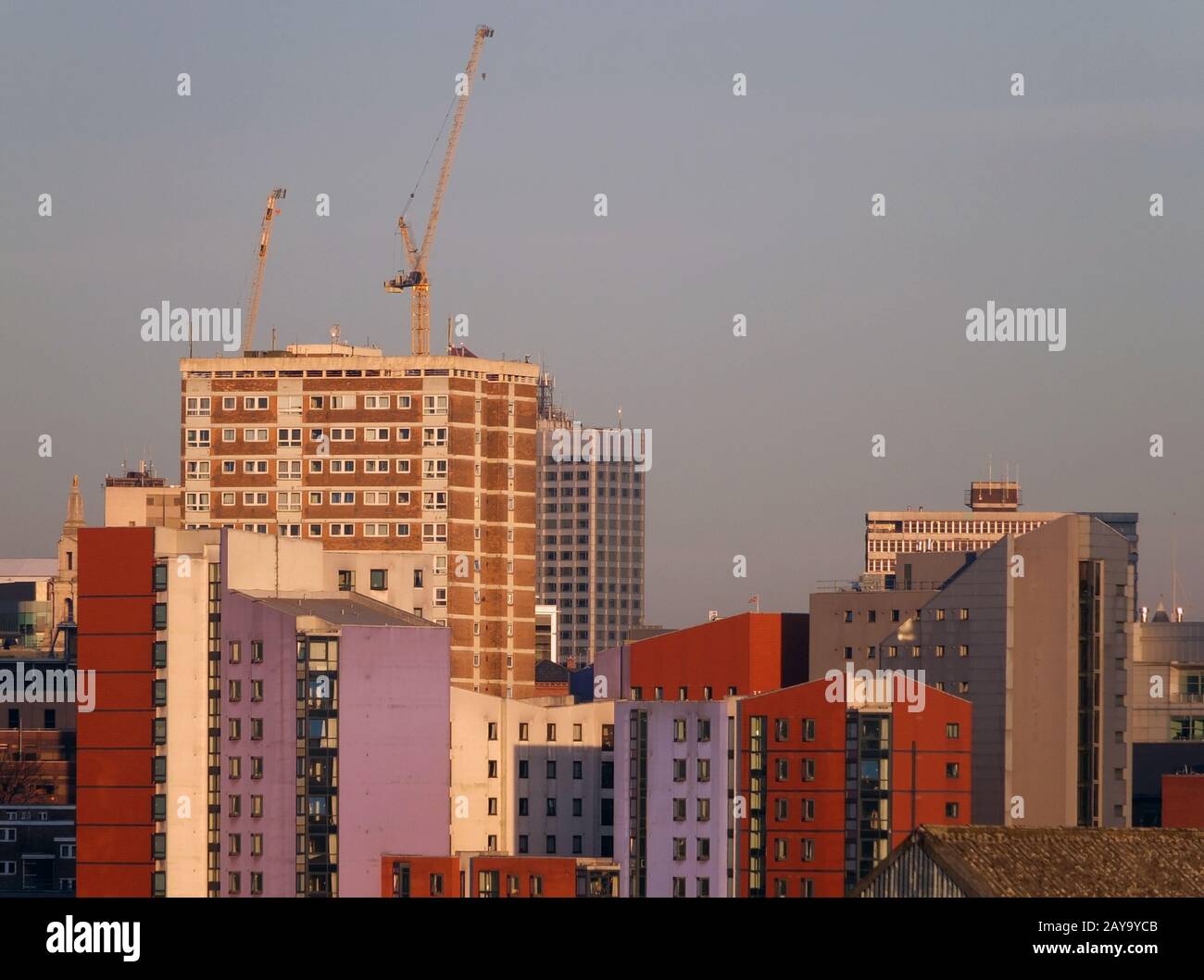 a cityscape view of tall modern residential developments in leeds city centre with cranes Stock Photo