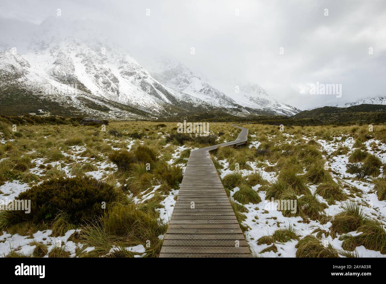 Curvy hanging pathway protects mountain ecosystem at Hooker Valley Track Stock Photo