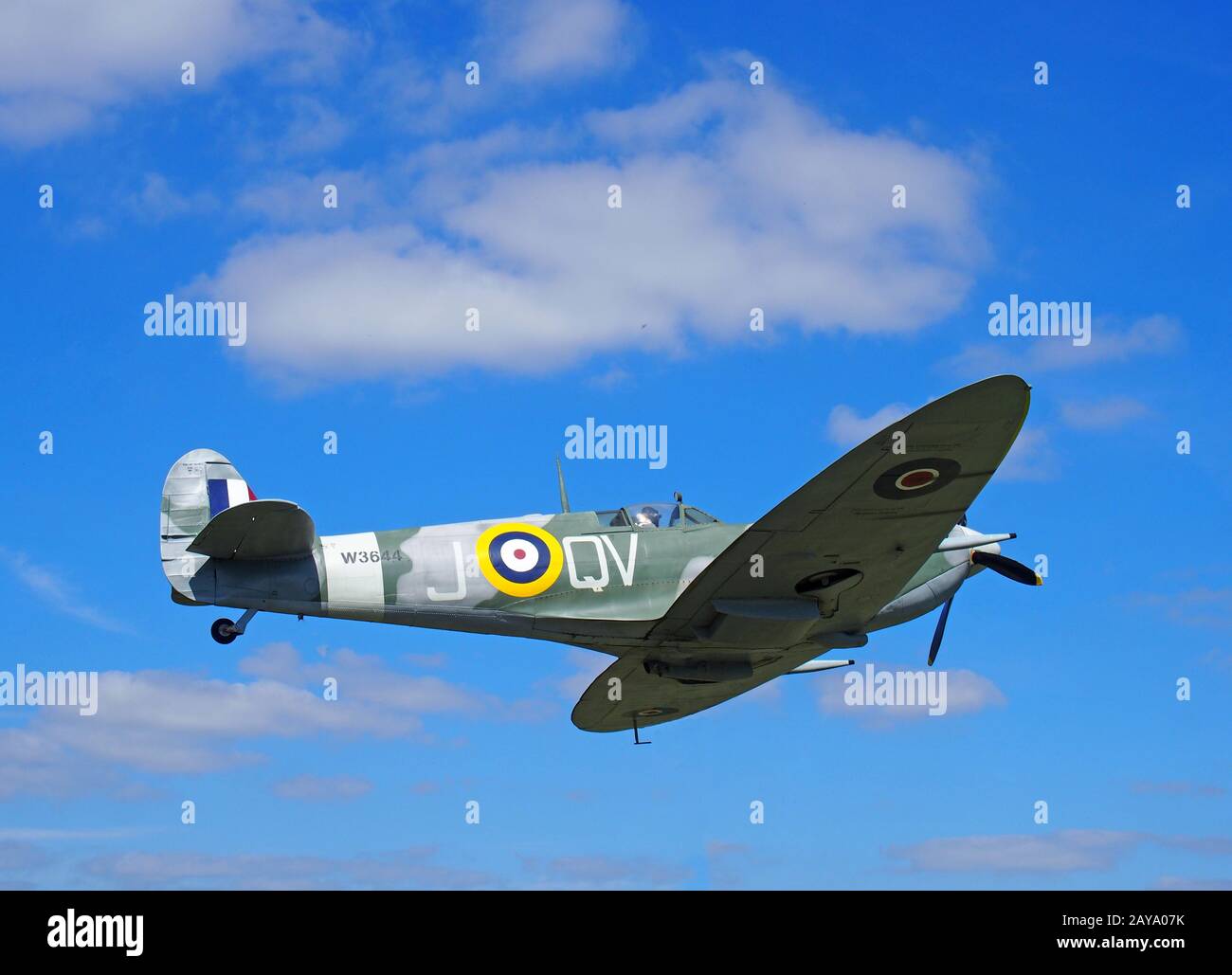 Vintage world war 2 Mark Vb spitfire in flight againt a blue sky with clouds Stock Photo