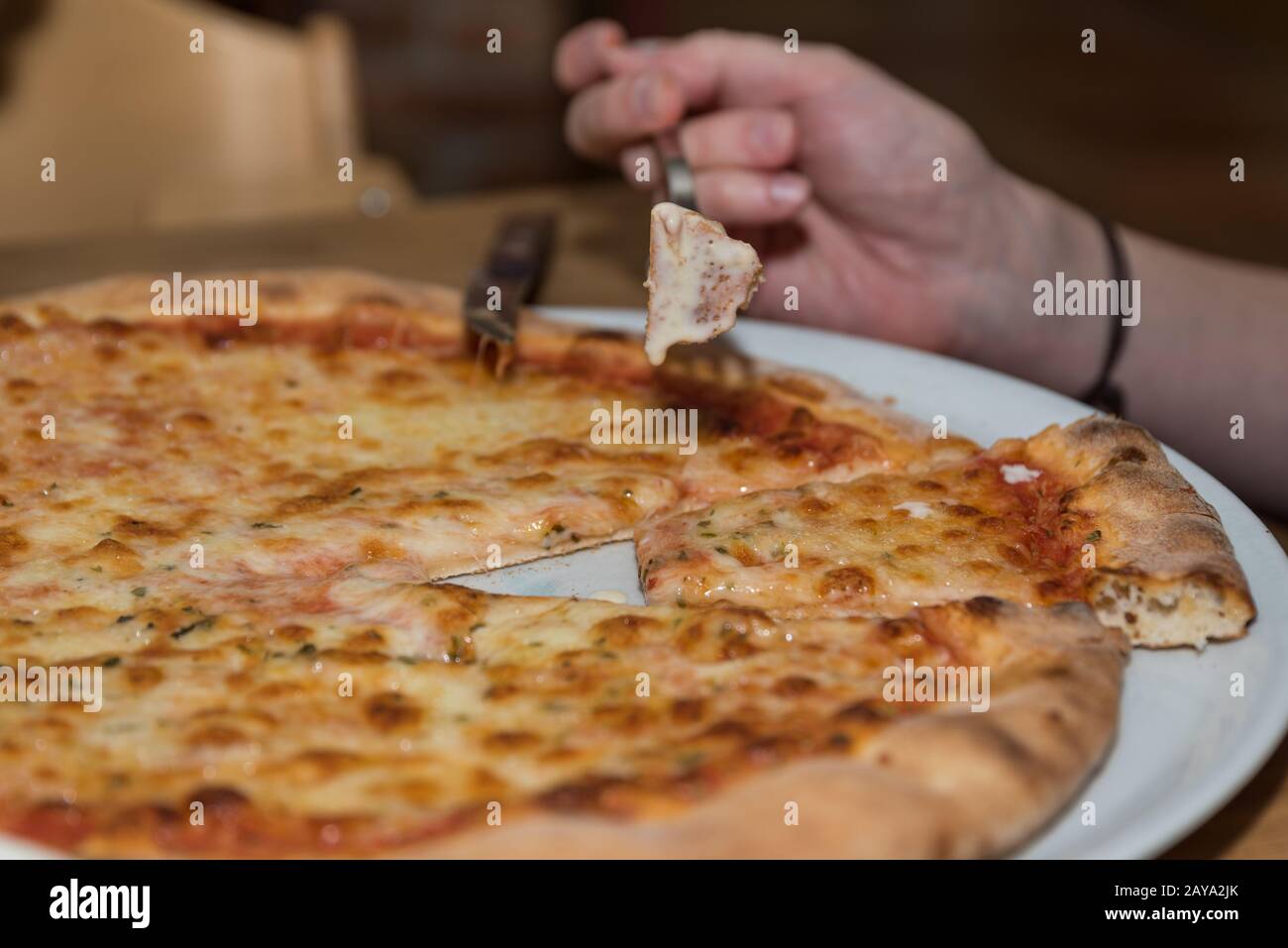 vegetarian Italian pizza Margherita self-prepared is eaten - close-up Stock Photo