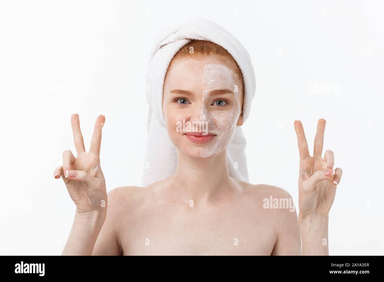 Beautiful caucasian woman applying mask on her face with two fingers ...
