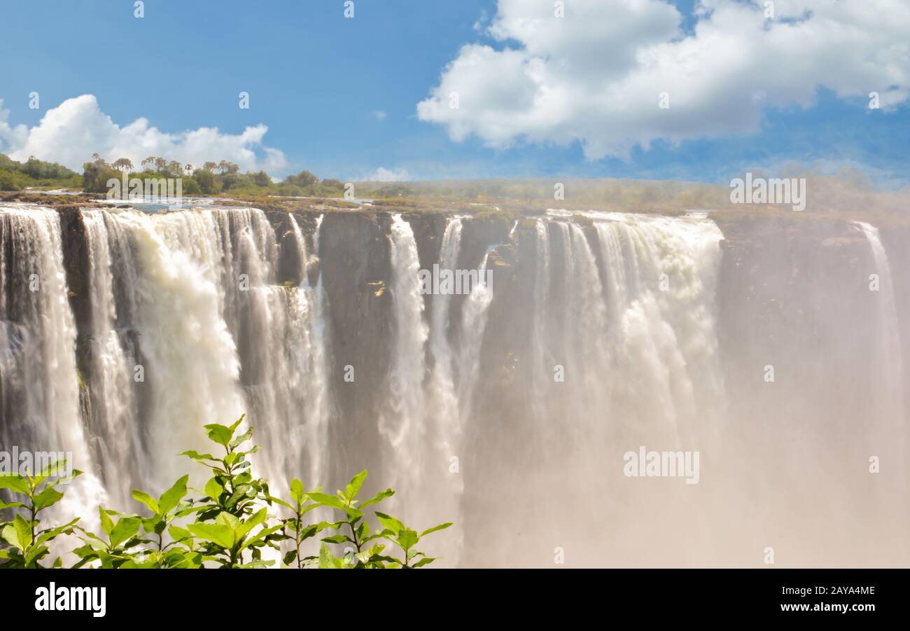 Victoria Falls is a waterfall near the cities of Victoria Falls in Zimbabwe and Livingstone in Zambi Stock Photo