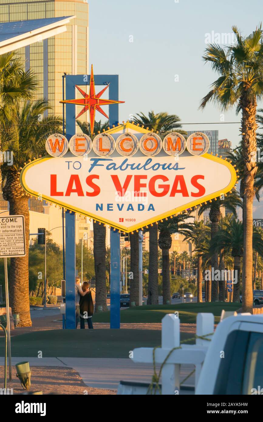 early morning sun illuminating las vegas sign and vegas skyline behind it Stock Photo