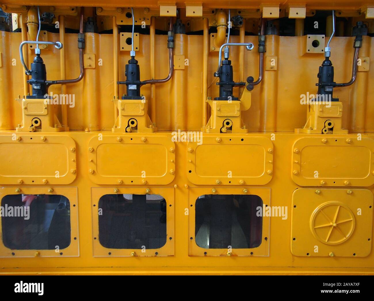 full frame image of a large yellow diesel engine used as an emergency standby electrical generator Stock Photo