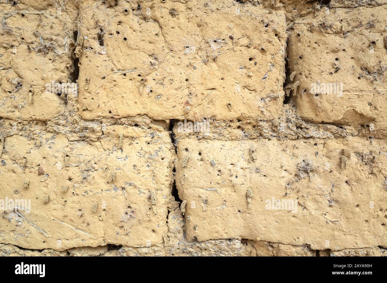 old yellow mud brick wall background Stock Photo