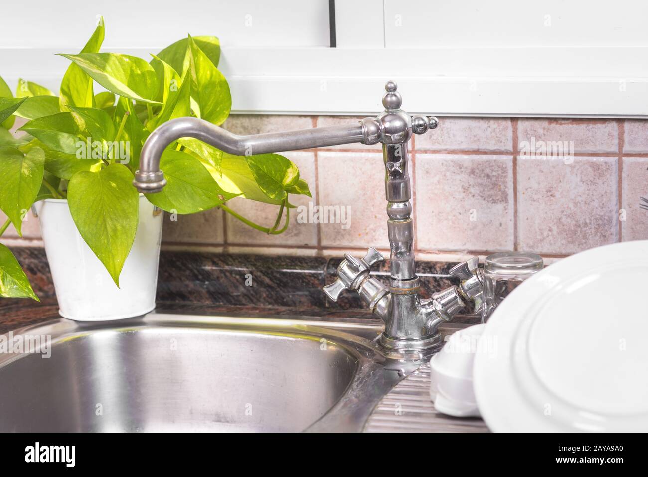 The Clean dishes are drying, on rustic kitchen metal sink Stock Photo - Alamy