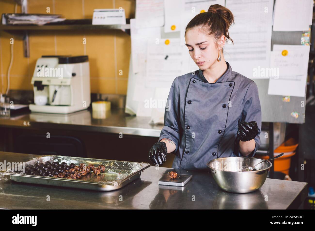 Subject profession and cooking pastry. young Caucasian woman with tattoo of  pastry chef in kitchen of restaurant preparing round Stock Photo - Alamy