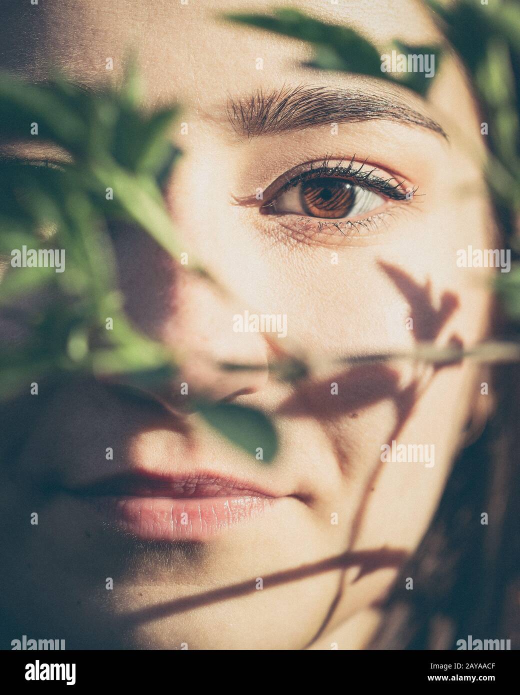 Young woman closeup face portrait in the woods Stock Photo - Alamy