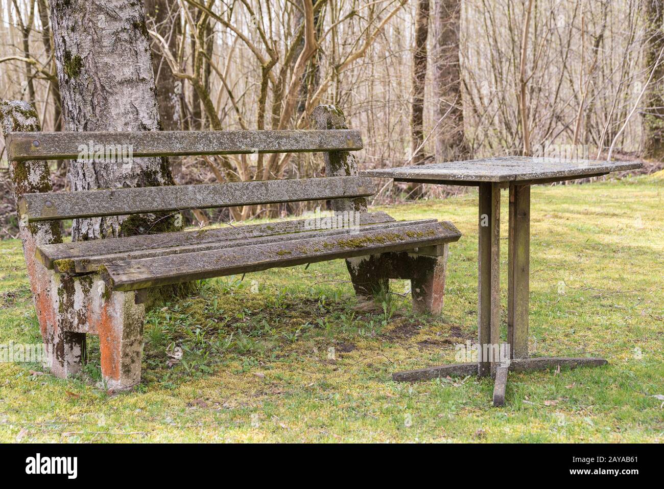 Old antique rest area with garden bench and table with stone top Stock Photo