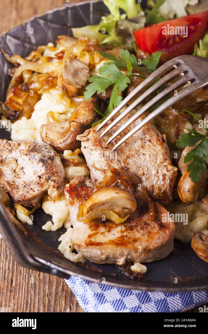 Pork fillet on spaetzle with mushrooms Stock Photo Alamy