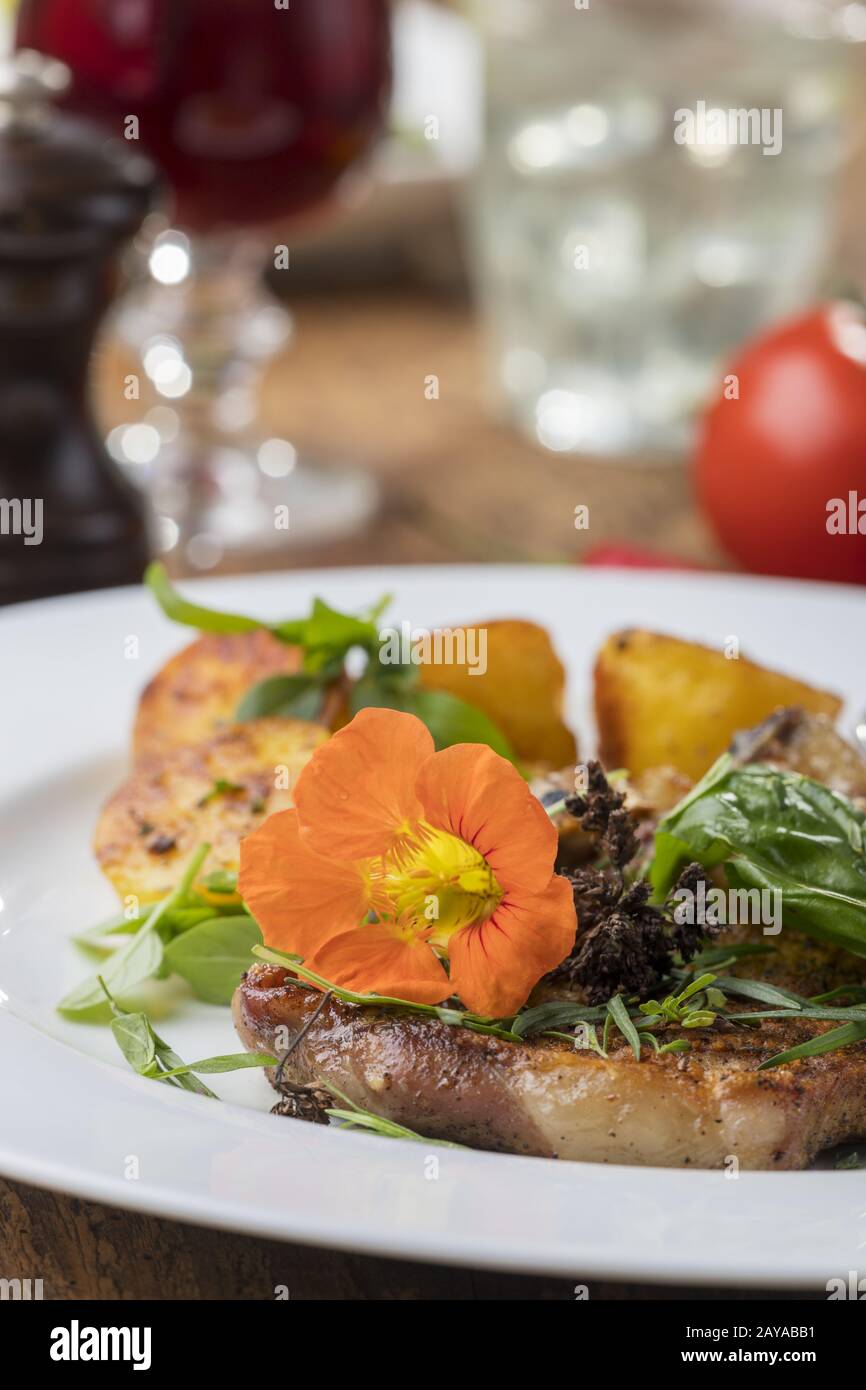 Grilled veal cutlet with nasturtium Stock Photo Alamy