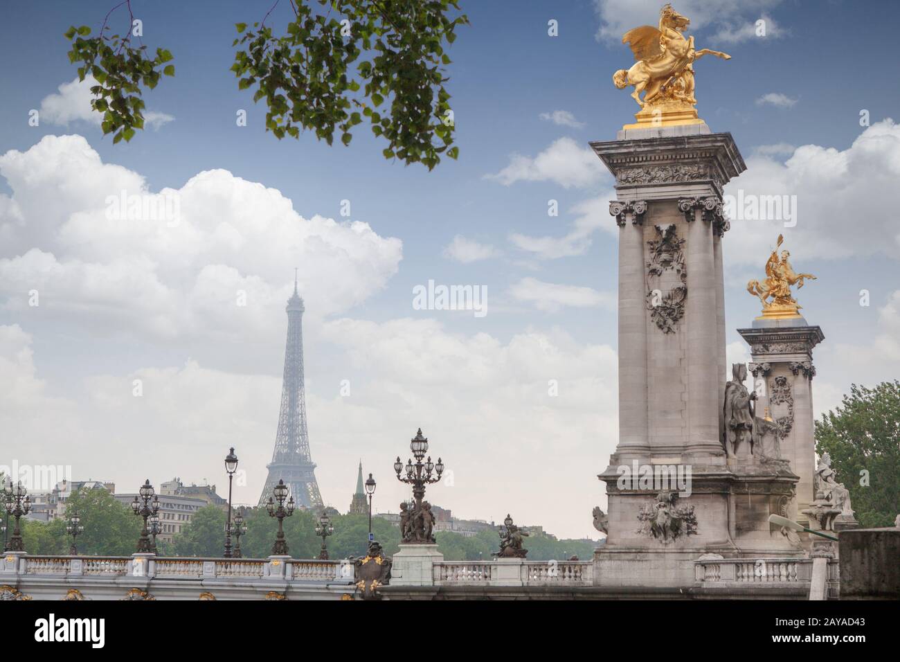 Golden monuments on the bridge Pont Alexander III bridge in Paris ...