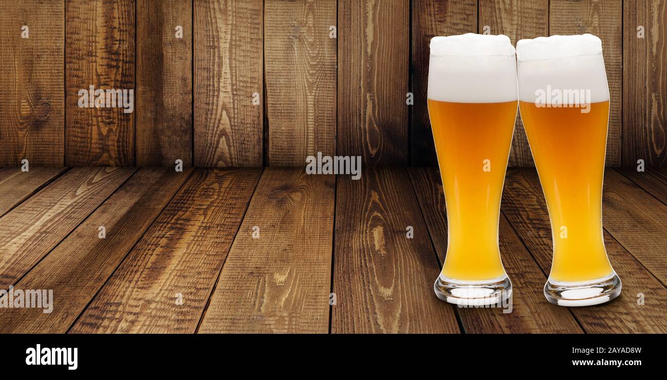 https://c8.alamy.com/comp/2AYAD8W/two-glasses-of-wheat-beer-making-cheers-on-a-wooden-background-2AYAD8W.jpg