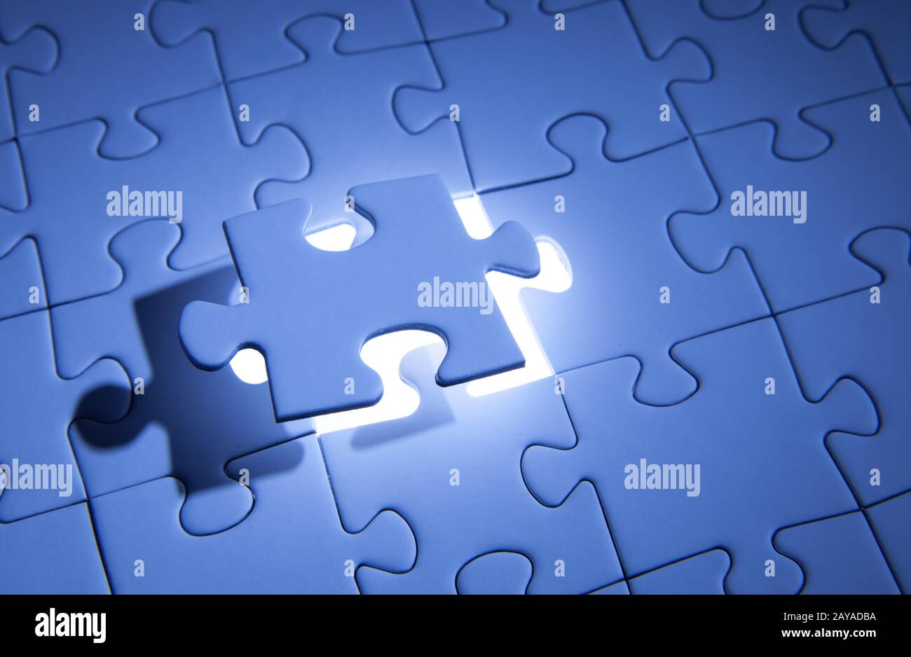 Blue jigsaw puzzle. Business solutions, solving problems,science technology and team building concept. Stock Photo