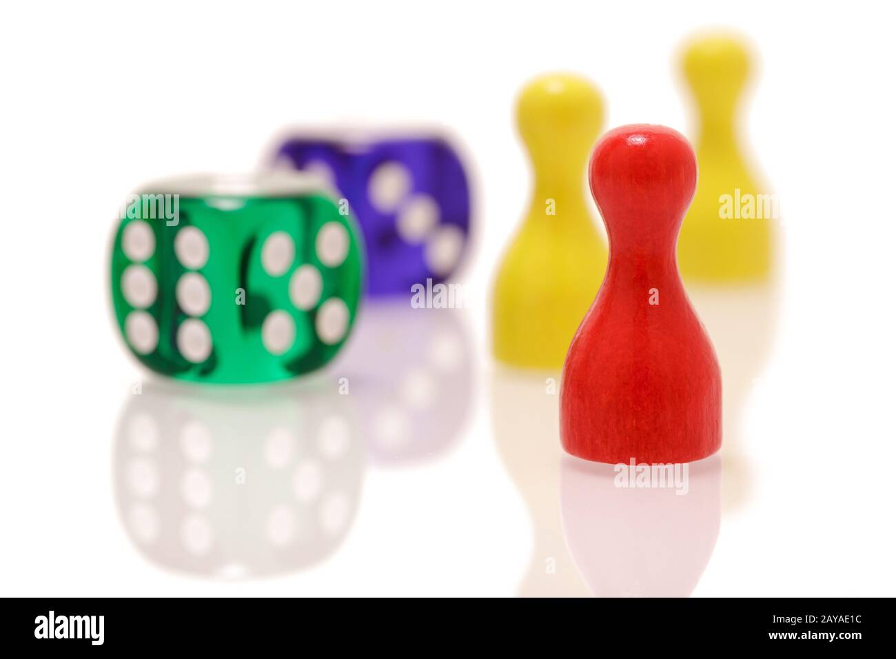 Gambling dices and wooden figures isolated on white background. Games, entertainment and luck concept. Stock Photo