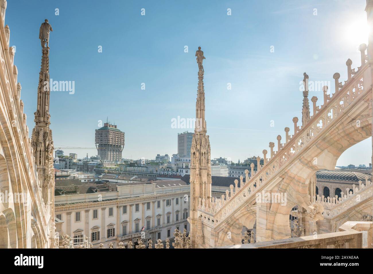 View from roof of Duomo to spires with statues and sity of Milan Stock Photo