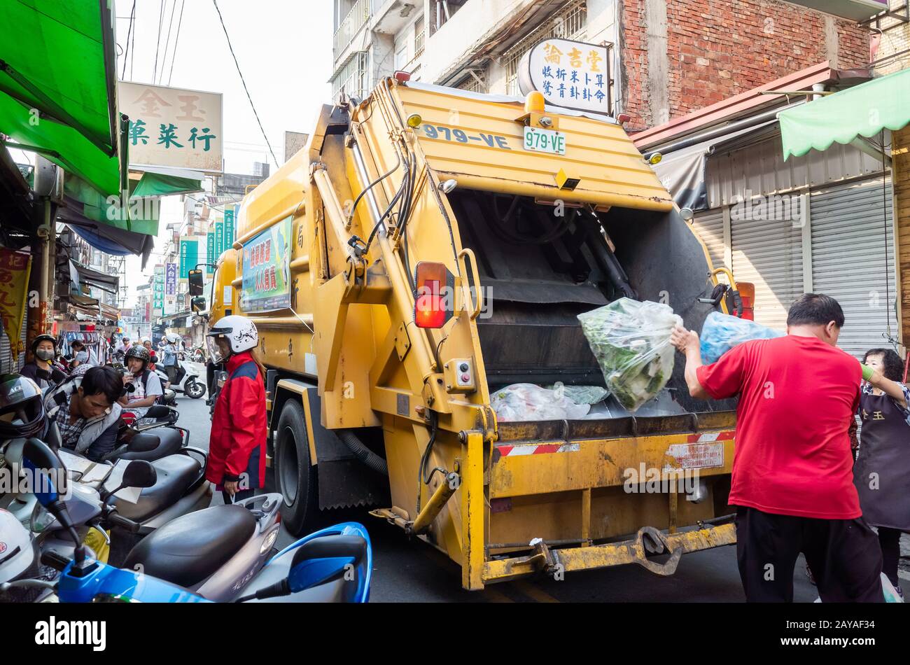 yellow garbage truck for collects garbages in the traditional