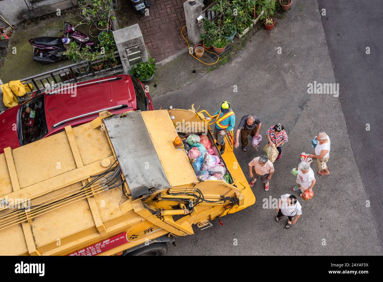 yellow garbage truck for collects garbages in the small lanes at Puli