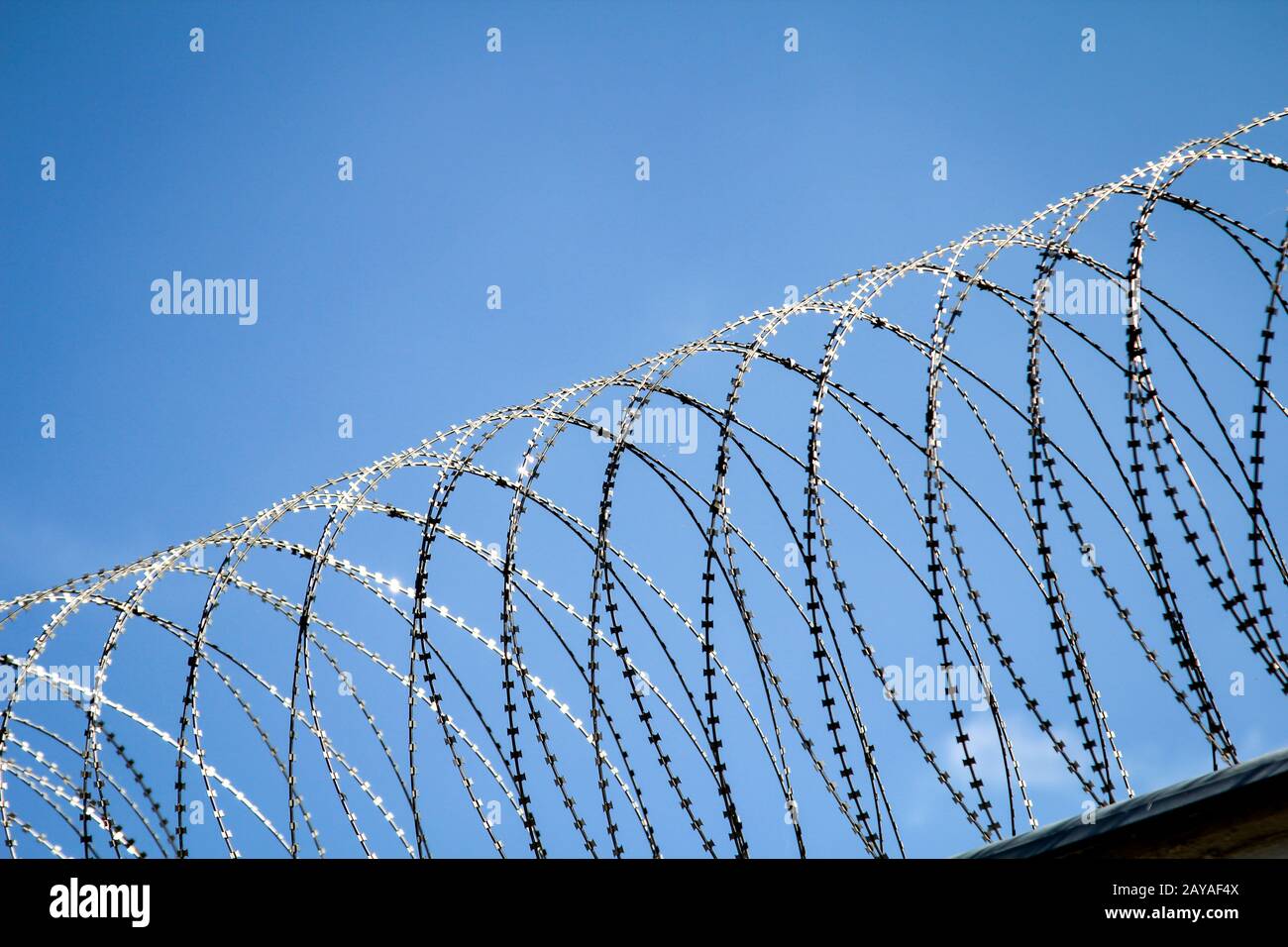 barbed wire on a fence of a prison to prevent unauthorized access Stock Photo