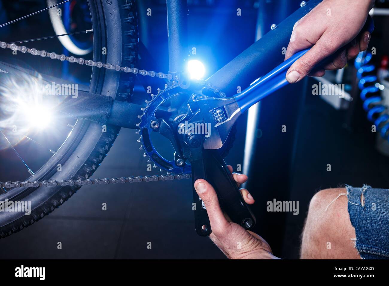 Closeup of man's hands bicycle mechanics in the shop uses instment to