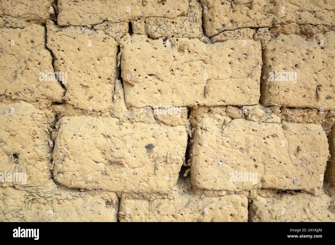 old yellow mud brick wall background Stock Photo