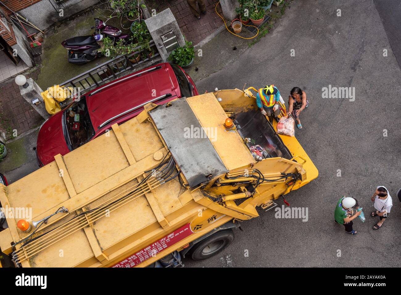 yellow garbage truck for collects garbages in the small lanes at Puli