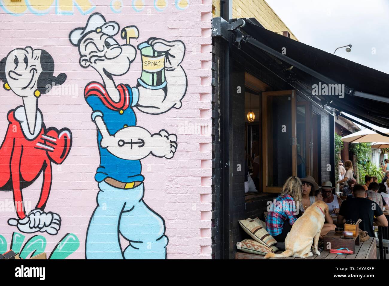 Byron Bay cafe, friends meet with their pets for morning coffee in Byron bay town centre,New South Wales,Australia Popeye and Ethel illustration Stock Photo