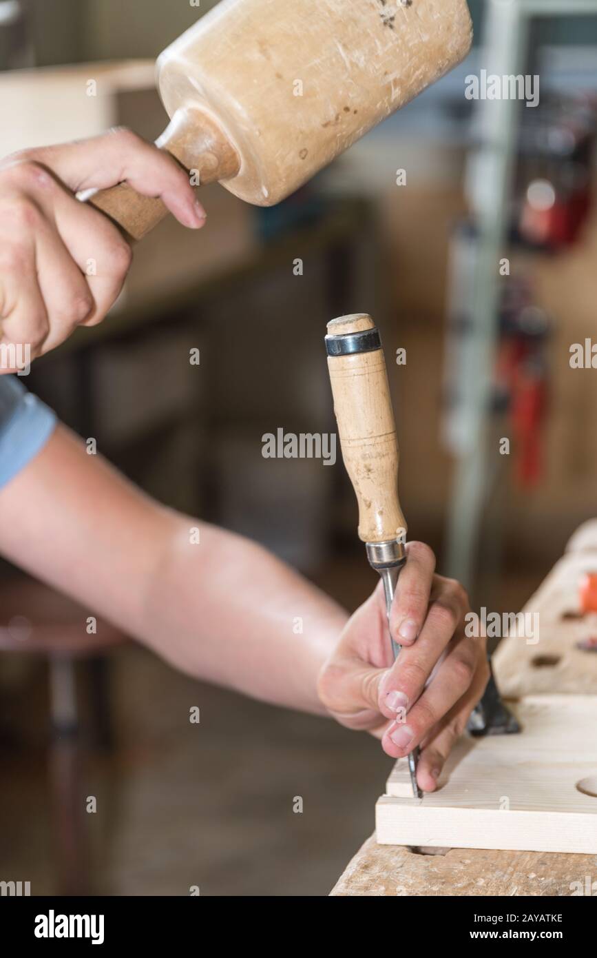 Joiner works with mallet and chisel wood - close-up Stock Photo