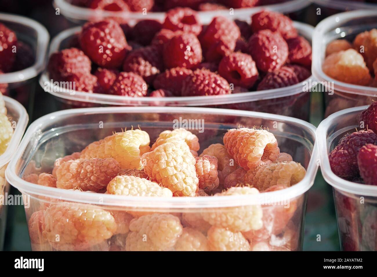 Large ripe raspberries in containers for sale Stock Photo - Alamy