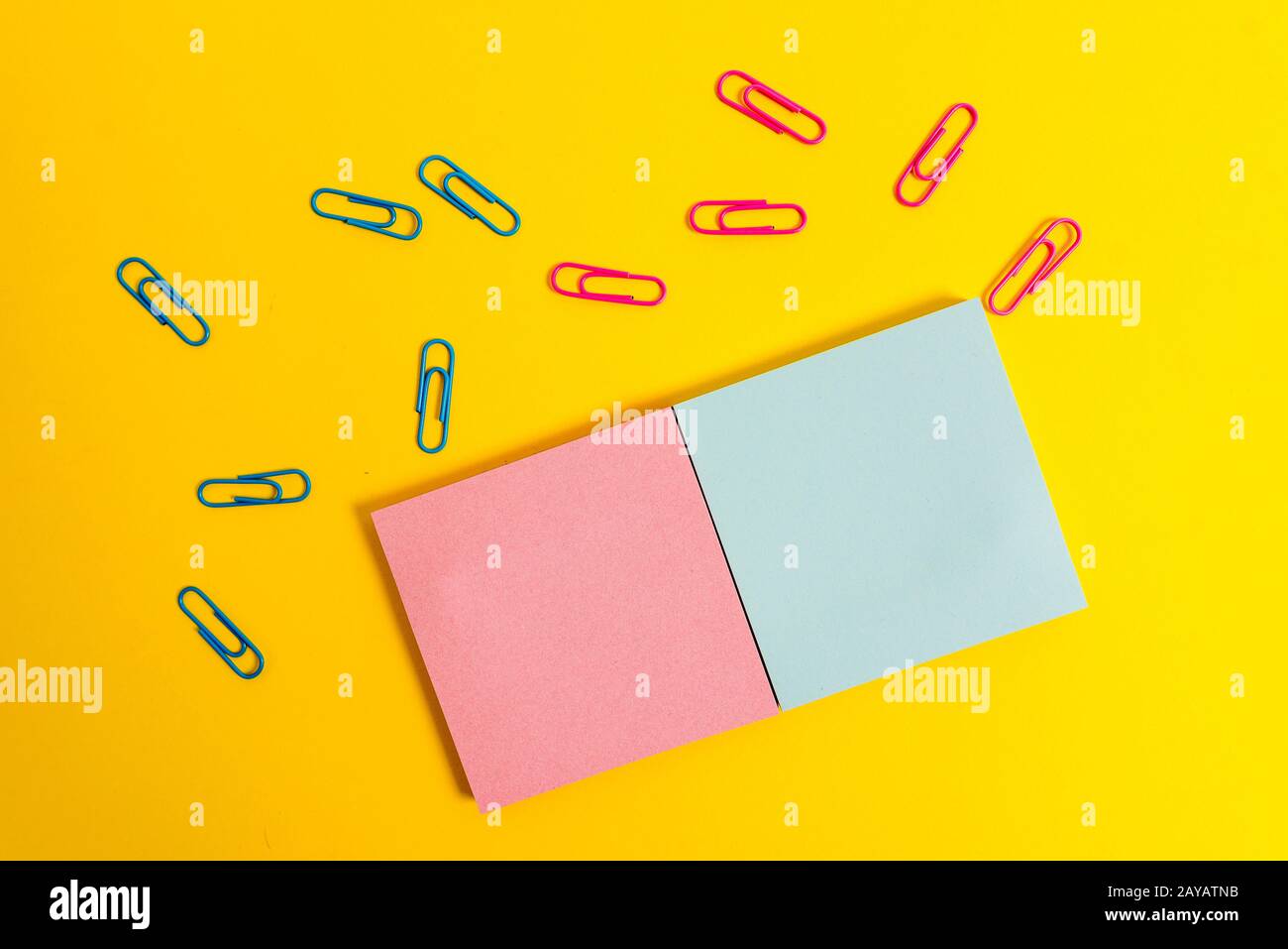 Front view colored blank notepads clips plain color background. Empty text important future events. What to do home school offic Stock Photo