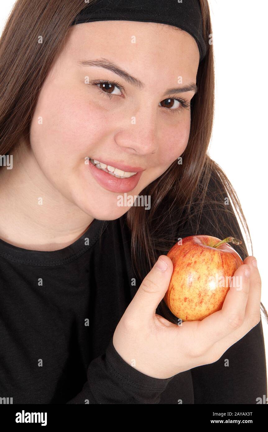 Close up of girl holding a red apple and smiling Stock Photo